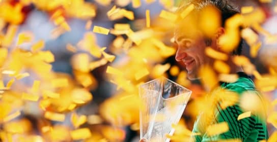 Champion with a trophy under confetti